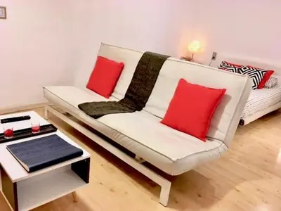 a living room with a white couch with two red pillows at Nice apartment in the middle of Born in Barcelona