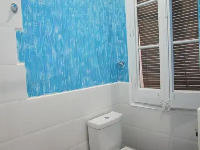 a bathroom with a white toilet and a window at Fira Plaza España Apartment 3ʳᵈ Floor Balcony in Barcelona