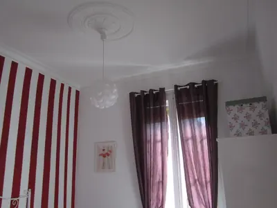 a room with red and white curtains and a chandelier at Fira Plaza España Apartment 3ʳᵈ Floor Balcony in Barcelona