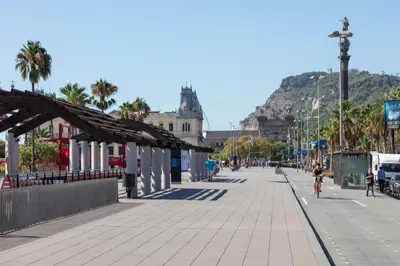 a person riding a bike down a street at Citytrip Barceloneta Beach in Barcelona