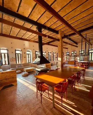 a large room with a large wooden table and chairs at El Molí Blanc in Lavid