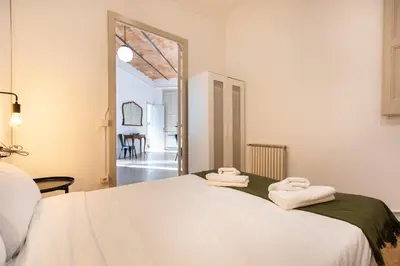 a bedroom with a bed with two towels on it at bp1- Piso para Grandes Grupos in Barcelona