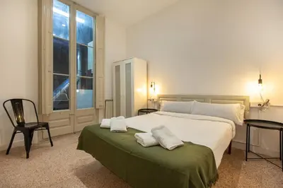 a bedroom with a large bed with two towels on it at bp1- Piso para Grandes Grupos in Barcelona