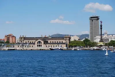 a large building on the water in front of a city at Pensión Casa Blanca in Barcelona