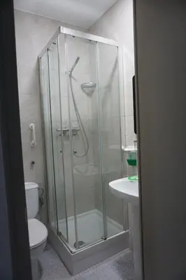 a bathroom with a shower with a toilet and a sink at Pensión Casa Blanca in Barcelona
