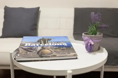 a table with a book on top of it at ApartsNouBcn Fira Barcelona in Hospitalet de Llobregat