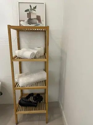 a wooden shelf with towels and towels at Hostal El Ninot in Barcelona