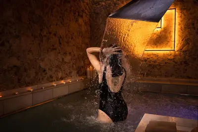 a woman is standing in the water in a pool at RVHotels Broquetas Spa Termal in Caldes de Montbui