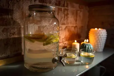 a glass jar filled with water and candles on a table at RVHotels Broquetas Spa Termal in Caldes de Montbui