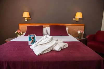 a hotel room with a bed with towels on it at RVHotels Spa Vila de Caldes - Adults only in Caldes de Montbui