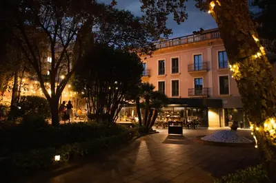 a building at night with lights in a courtyard at RVHotels Spa Vila de Caldes - Adults only in Caldes de Montbui