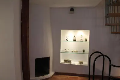 a shelf with vases and other items on a wall at Old Navy House in Badalona