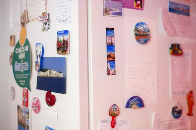 a white refrigerator with magnets and pictures on it at Casa Tortilla Sagrada Familia in Barcelona