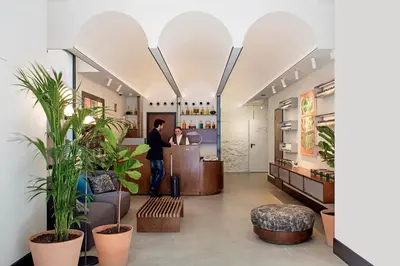 a lobby with two people standing at a counter at Praktik Èssens in Barcelona