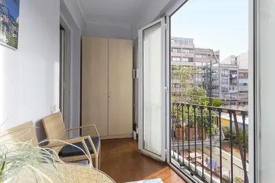 a room with a balcony with a view of a city at Luxury & Elegant Apartment in the centre in Barcelona