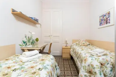 a room with two beds and a desk in it at Luxury & Elegant Apartment in the centre in Barcelona