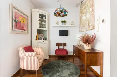 a living room with a chair and a table at Beautiful & Luxury Apartment centrally-located in Barcelona