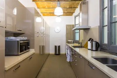 a large kitchen with a sink and a microwave at Quartprimera Apartments in Barcelona