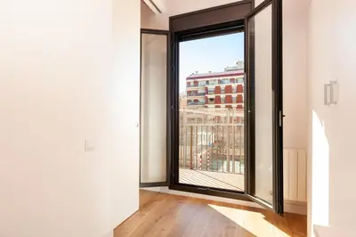 a room with a large window with a view at Akira Flats Urgell apartment in Barcelona
