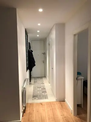 a hallway with white walls and a hallway with a rug on the floor at Akira Flats Urgell apartment in Barcelona