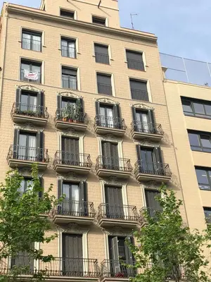 a tall building with balconies on the side of it at Akira Flats Urgell apartment in Barcelona