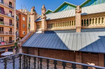 a building with a metal roof on a street at Charming & Convenient Apartment Near Plaza Espanya in Barcelona
