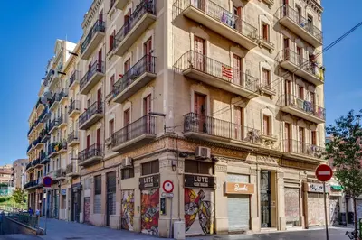 a tall building on a street with graffiti on it at Charming & Convenient Apartment Near Plaza Espanya in Barcelona