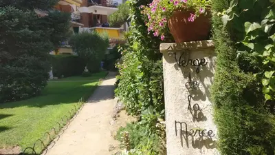 a stone wall with graffiti on it with flowers at Charming Attic with Pool and Seaviews in Arenys de Mar