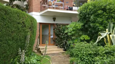 a house with a staircase leading up to the front door at Charming Attic with Pool and Seaviews in Arenys de Mar