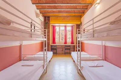 a room with three bunk beds and a window at Bird House in Barcelona