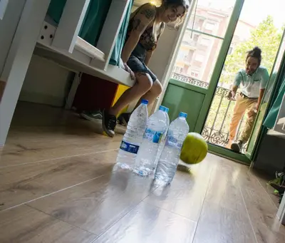 a woman is standing next to a bunch of water bottles at Black Swan Hostel Barcelona in Barcelona