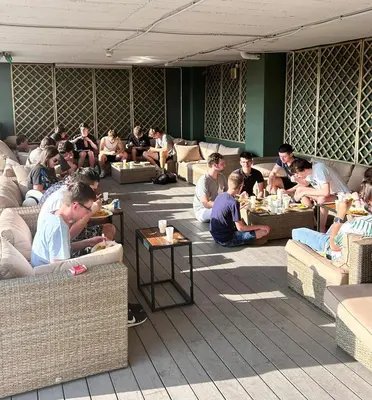 a group of people sitting on couches in a room at Twentytu Hostel Barcelona in Barcelona