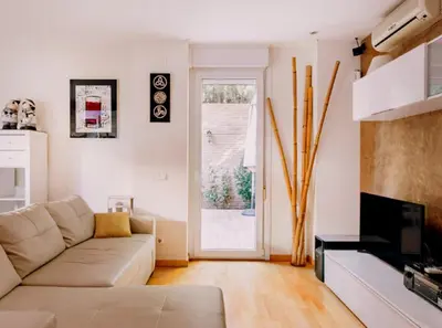 a living room with a couch and a fireplace at Bonito duplex con piscina en Barcelona&playa in Tiana