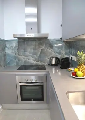 a kitchen with a stove and a bowl of fruit at Cosmo Apartments Consell de Cent - Plaza Universitat in Barcelona