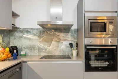 a kitchen with a stove top oven and a microwave at Cosmo Apartments Consell de Cent - Plaza Universitat in Barcelona