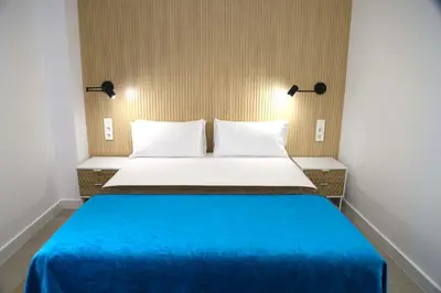 a bedroom with a blue bed with two pillows at Cosmo Apartments Consell de Cent - Plaza Universitat in Barcelona