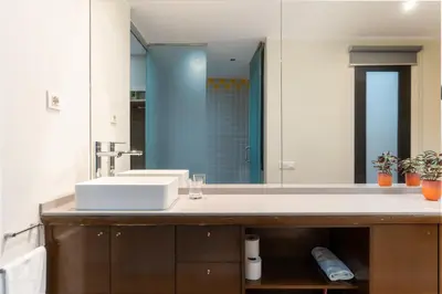 a bathroom with a sink and a large mirror at SibsBcn COLISEUM - Cozy and Central in Barcelona
