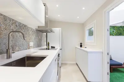 a kitchen with white counters and a sink at Art House Cathedral Sagrada Familia in Barcelona