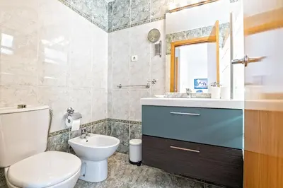 a bathroom with a toilet and a sink at Apartamento lujo& piscina junto Barcelona Centro in Ripollet