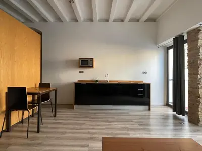 a living room with a table and a sink at Apartamento en Vilanova in Vilanova i la Geltrú