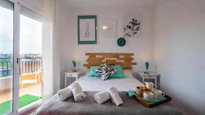 a bedroom with a bed with towels on it at Bed&Bcn Glories in Barcelona
