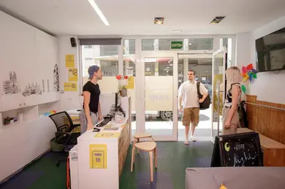 a group of people standing in a room at Onefam Ramblas in Barcelona