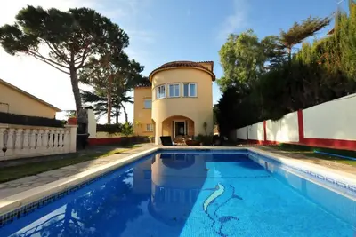 a house with a swimming pool in front of a house at House with Pool and Sea Views in Alella