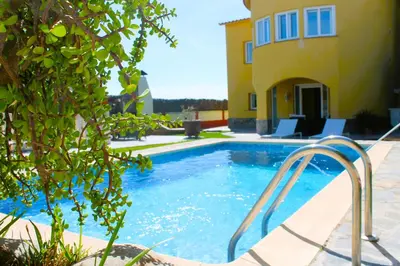 a swimming pool in front of a house at House with Pool and Sea Views in Alella