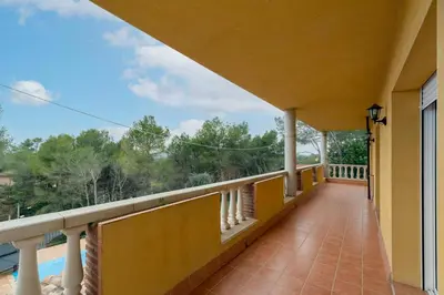 a balcony of a house with a view at Casa Xixella a 15 min de Sitges in Olivella