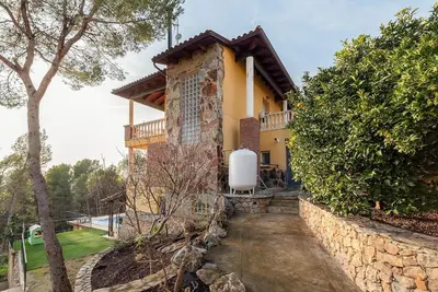 a house with a water heater on the side of it at Casa Xixella a 15 min de Sitges in Olivella
