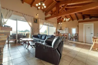 a living room with a leather couch and a table at Casa Xixella a 15 min de Sitges in Olivella