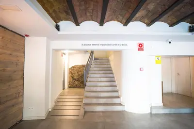 a staircase in a building with a wooden ceiling at Dynamic Hotels Caldetes Barcelona in Caldes d'Estrac