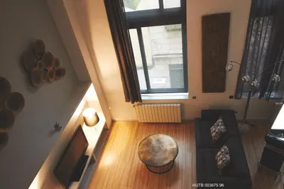 an overhead view of a living room with a couch and a window at Alcam Alio Cine in Barcelona