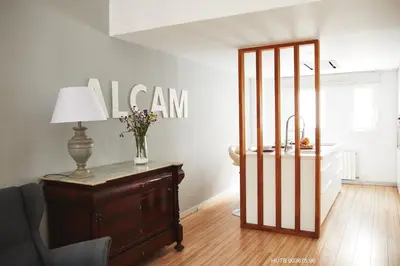 a room with a dresser and a table with a lamp at Alcam Alio Cine in Barcelona